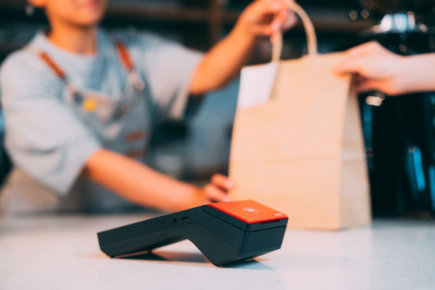Customer paying by card at a takeaway counter